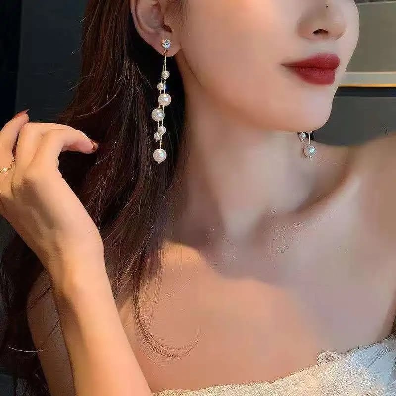 Long tassel pearl stone EarringsMaterial:- Alloy+ Pearls + StonesColor:- Gold