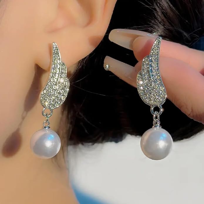 Angel Wings Earrings with pearl Material:- Alloy Copper+ Stones + Silver plating Colour:- Silver