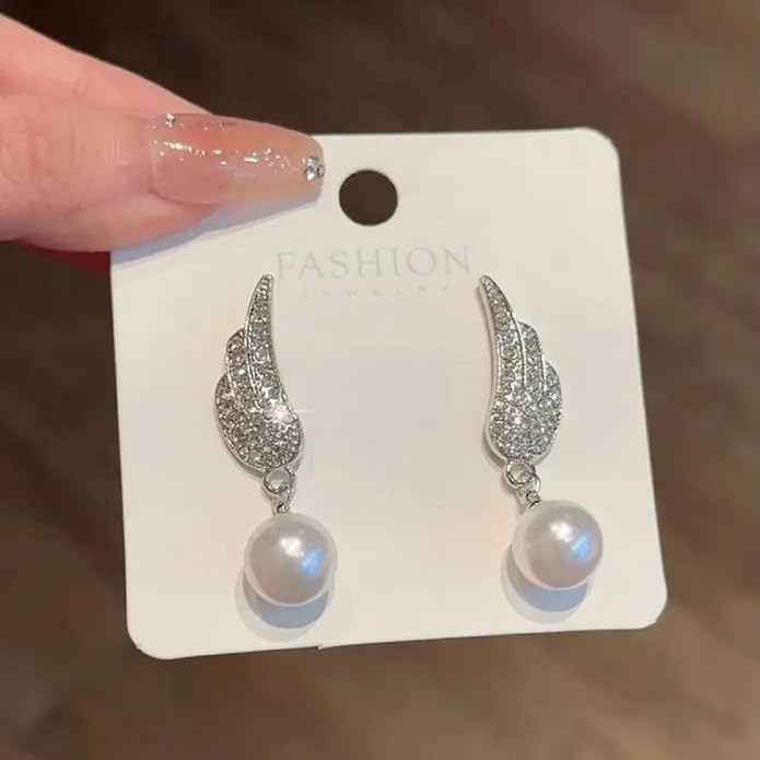 Angel Wings Earrings with pearl Material:- Alloy Copper+ Stones + Silver plating Colour:- Silver