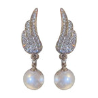 Angel Wings Earrings with pearl Material:- Alloy Copper+ Stones + Silver plating Colour:- Silver