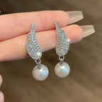 Angel Wings Earrings with pearl Material:- Alloy Copper+ Stones + Silver plating Colour:- Silver