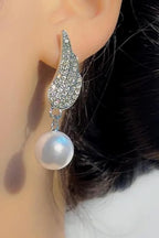 Angel Wings Earrings with pearl Material:- Alloy Copper+ Stones + Silver plating Colour:- Silver
