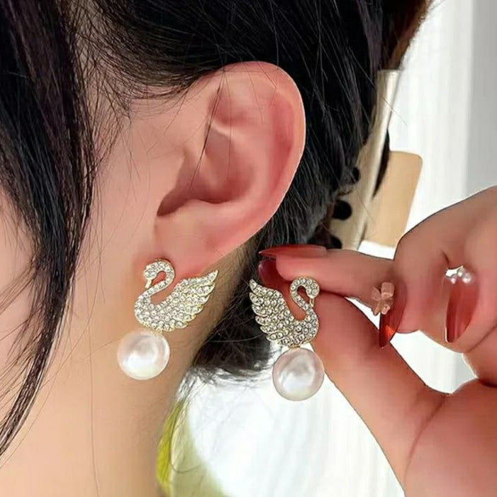Swan stud earrings for womenMaterial:- Alloy zinc, pearl and zirconColor :- Gold