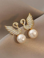 Swan stud earrings for womenMaterial:- Alloy zinc, pearl and zirconColor :- Gold