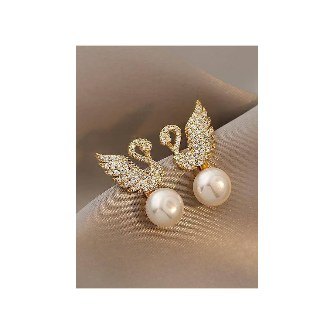 Swan stud earrings for womenMaterial:- Alloy zinc, pearl and zirconColor :- Gold