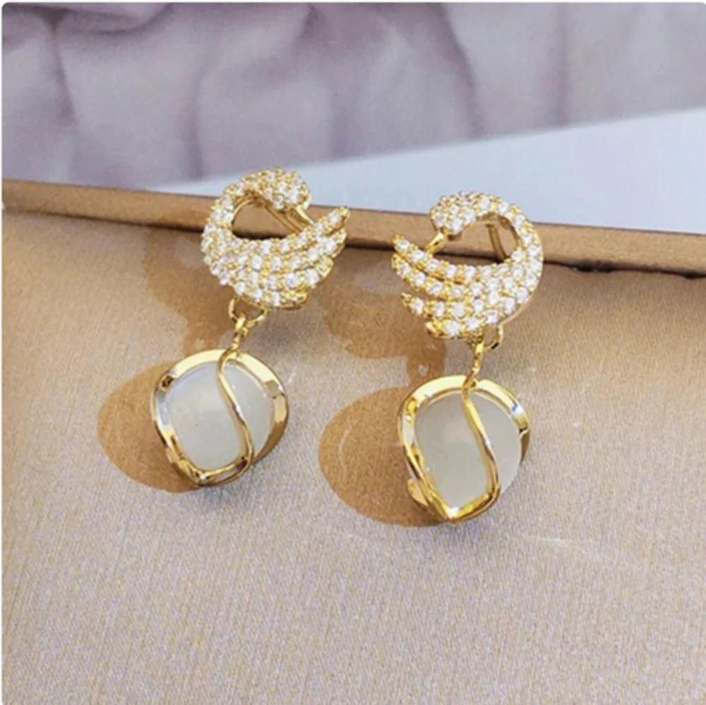 Swan Shape Fashionable earrings Color :- Gold Material  :- Stones and Zircon Alloy