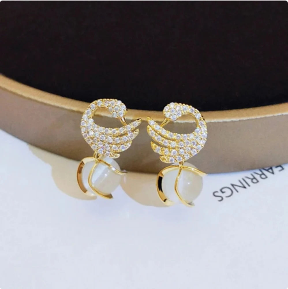 Swan Shape Fashionable earrings Color :- Gold Material  :- Stones and Zircon Alloy