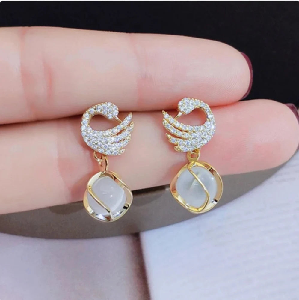 Swan Shape Fashionable earrings Color :- Gold Material  :- Stones and Zircon Alloy